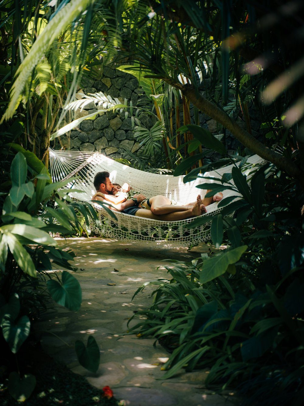 Floor-to-ceiling windows of the Premium Jabu framed by tropical planting